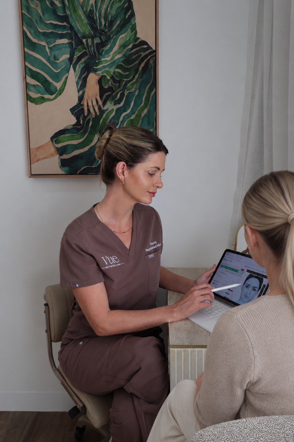 Chantel, Registered Nurse, talking through a skin treatment plan with a client in the Vue clinic